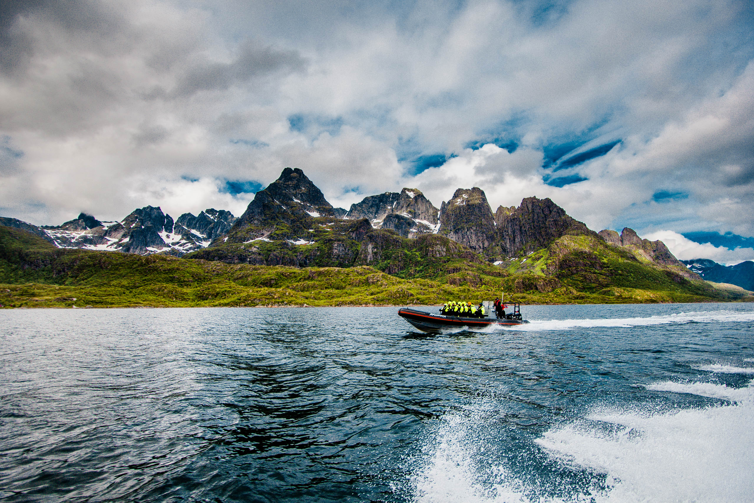 RIB boat cruising along the coast of Lofoten